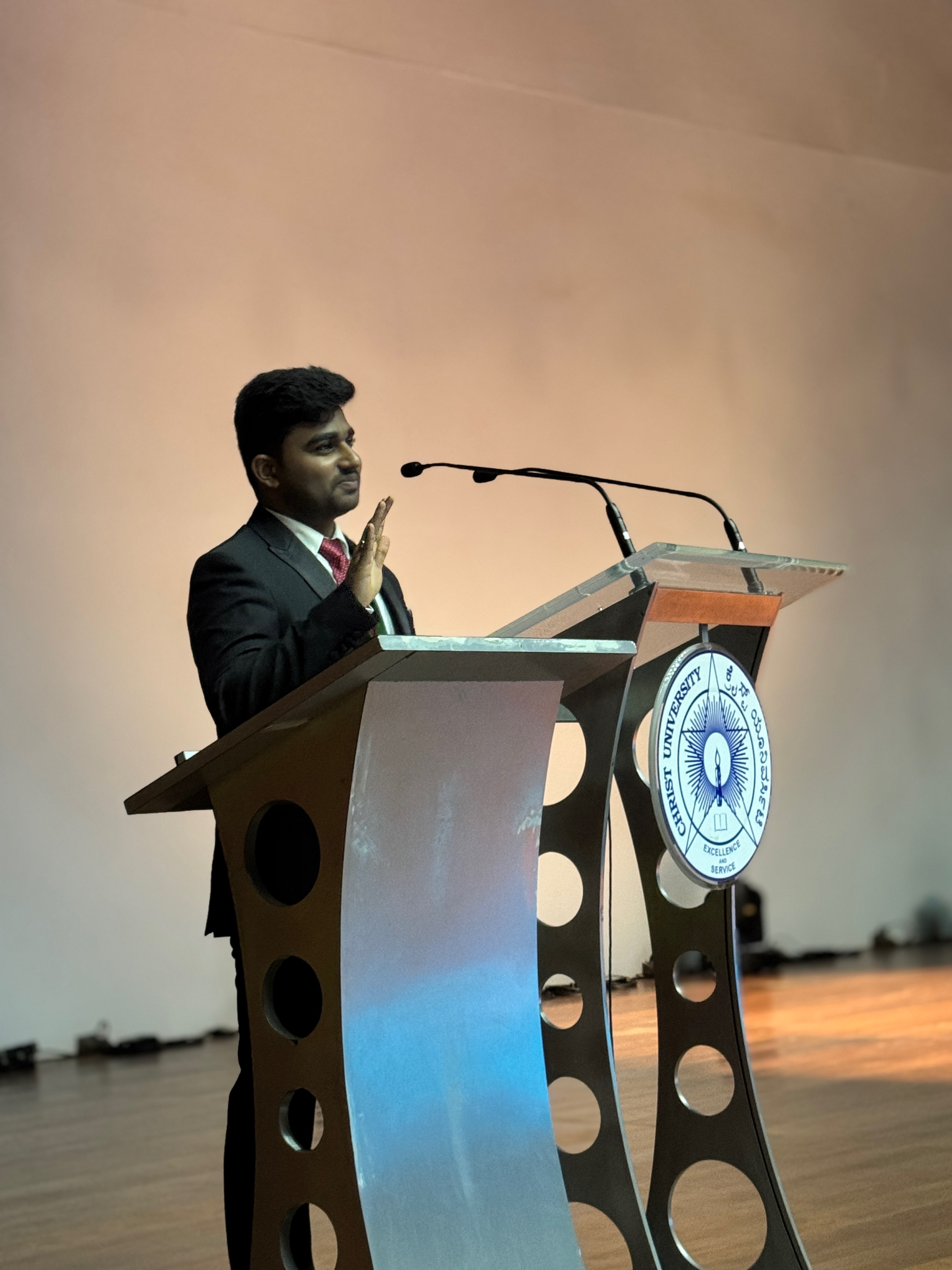 Roshan Rajkumar Sivakumar at the official Christ University podium during setup and rehearsal stage of a Pioneer Club event Bengaluru